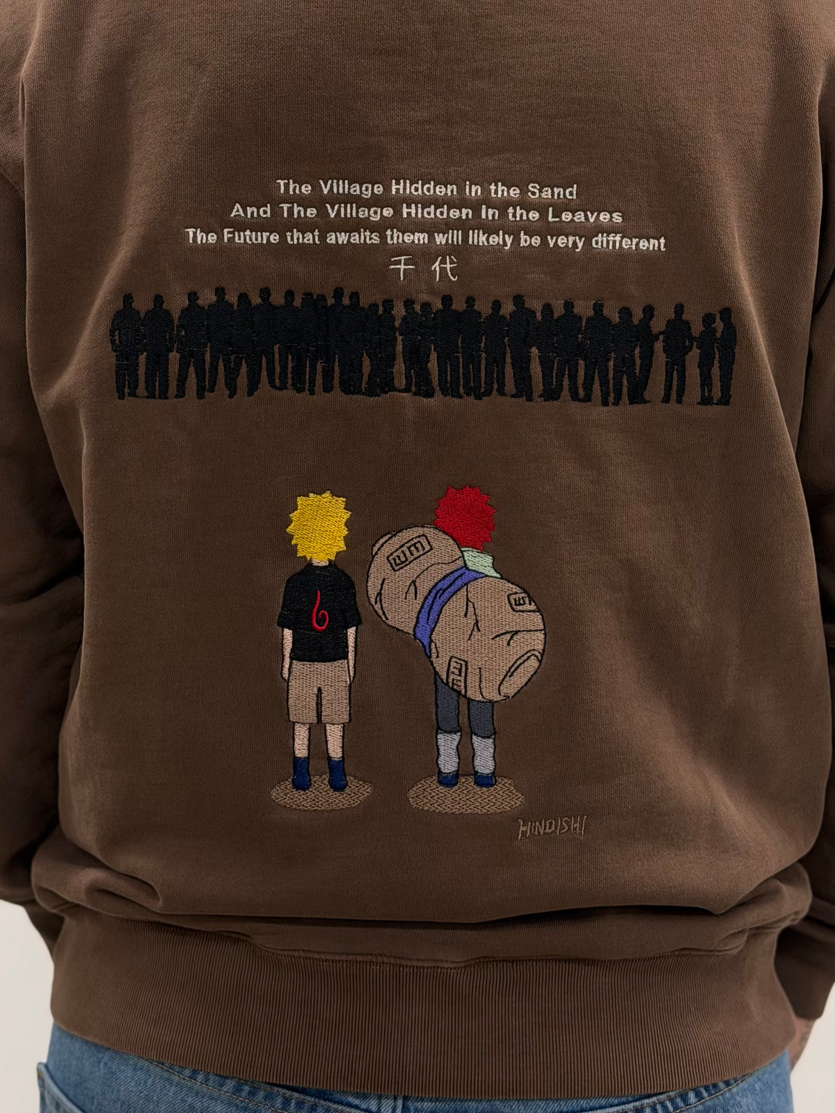 Close-up of back embroidery showing young Naruto and Gaara facing a crowd of silhouettes, Naruto anime streetwear
