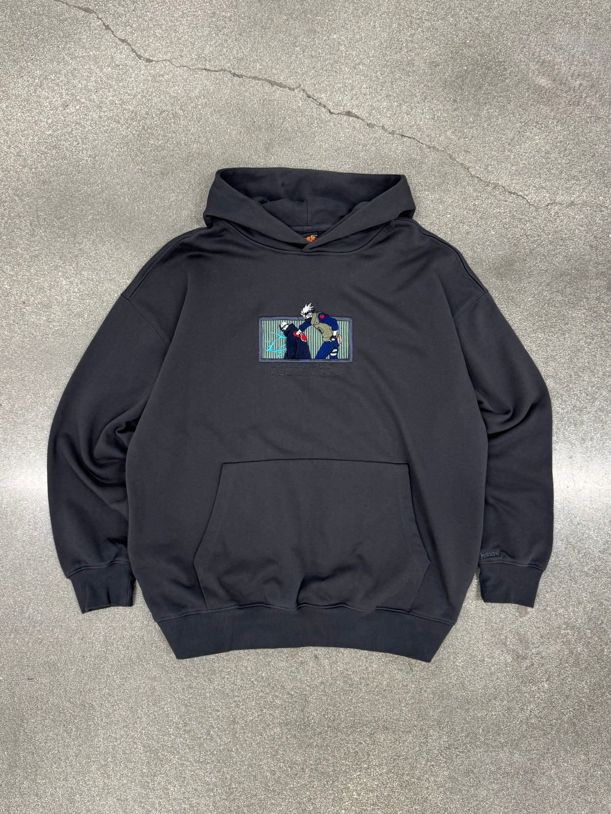 Copy Ninja Killshot dark gray hoodie laid flat, front view with embroidered Kakashi vs Kakuzu patch