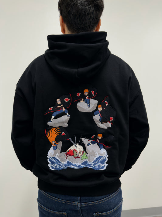 Model wearing The Last Message black hoodie with embroidered Jiraiya vs Pain battle scene on the back