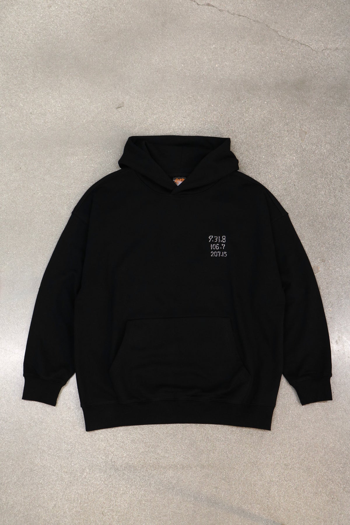 The Last Message black hoodie laid flat, front view with Jiraiya's coded message embroidered on the chest
