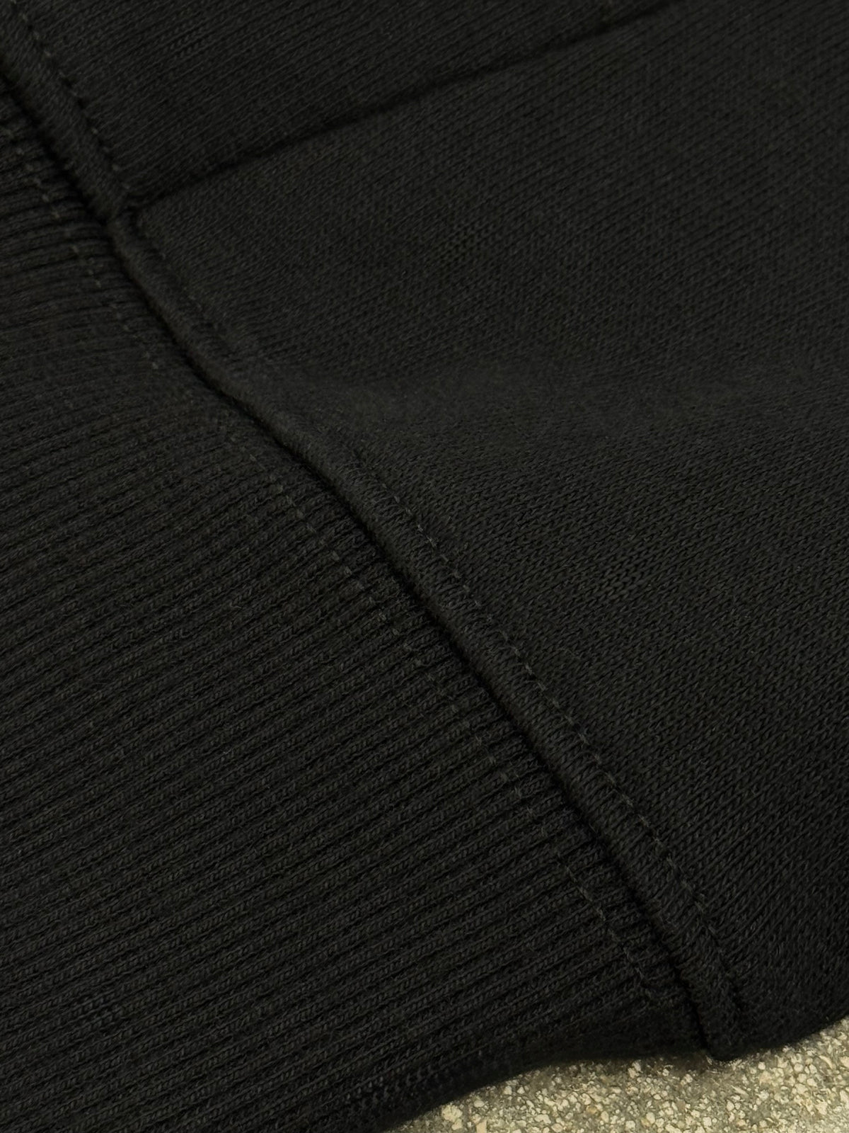 Close-up of the black fleece fabric, ribbed cuff and stitching of the Jiraiya vs Pain hoodie