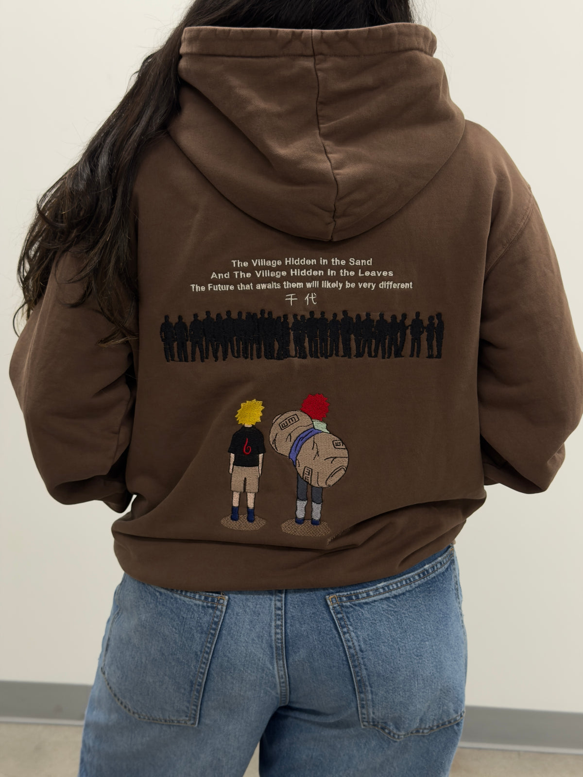 Back of the Two Tails Fates hoodie: embroidered young Naruto and Gaara with Chiyo's quote about the Sand and Leaf villages